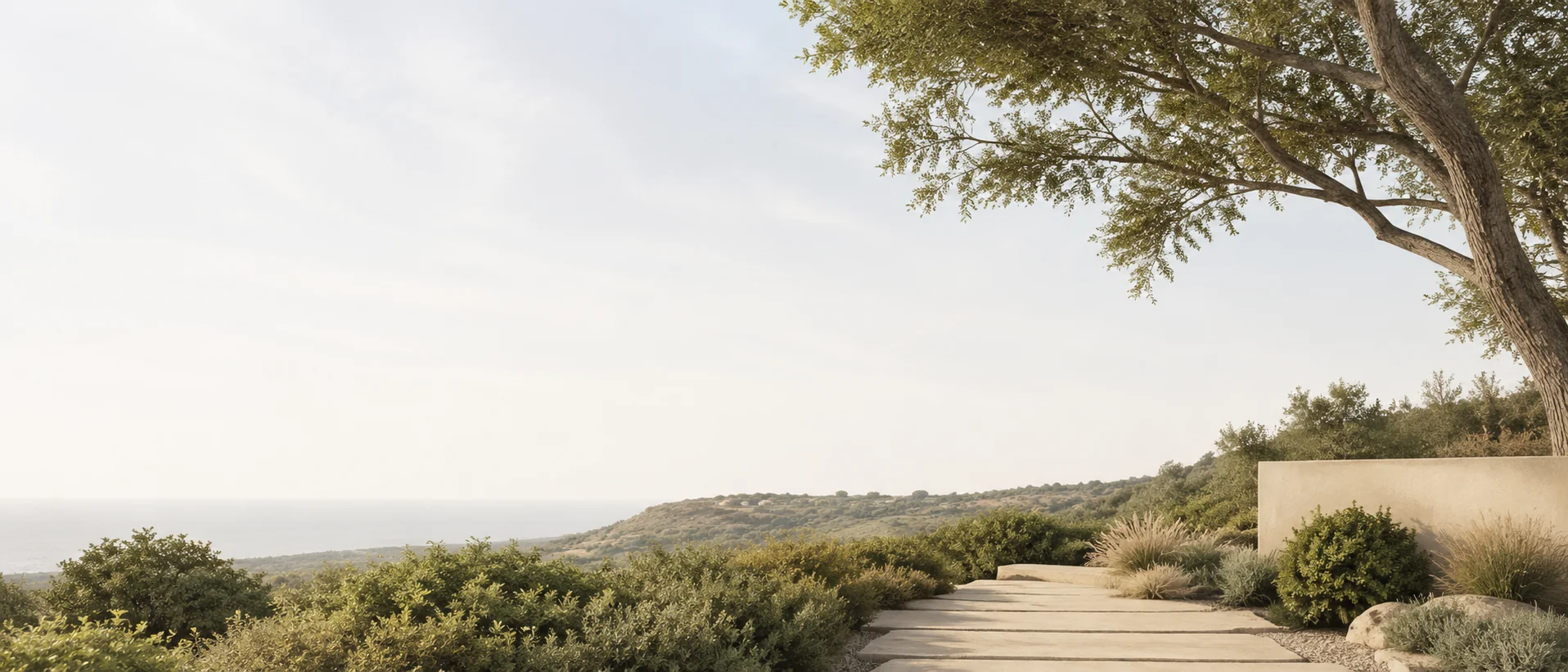 Landscaped architectural path opening towards a wide coastal horizon
